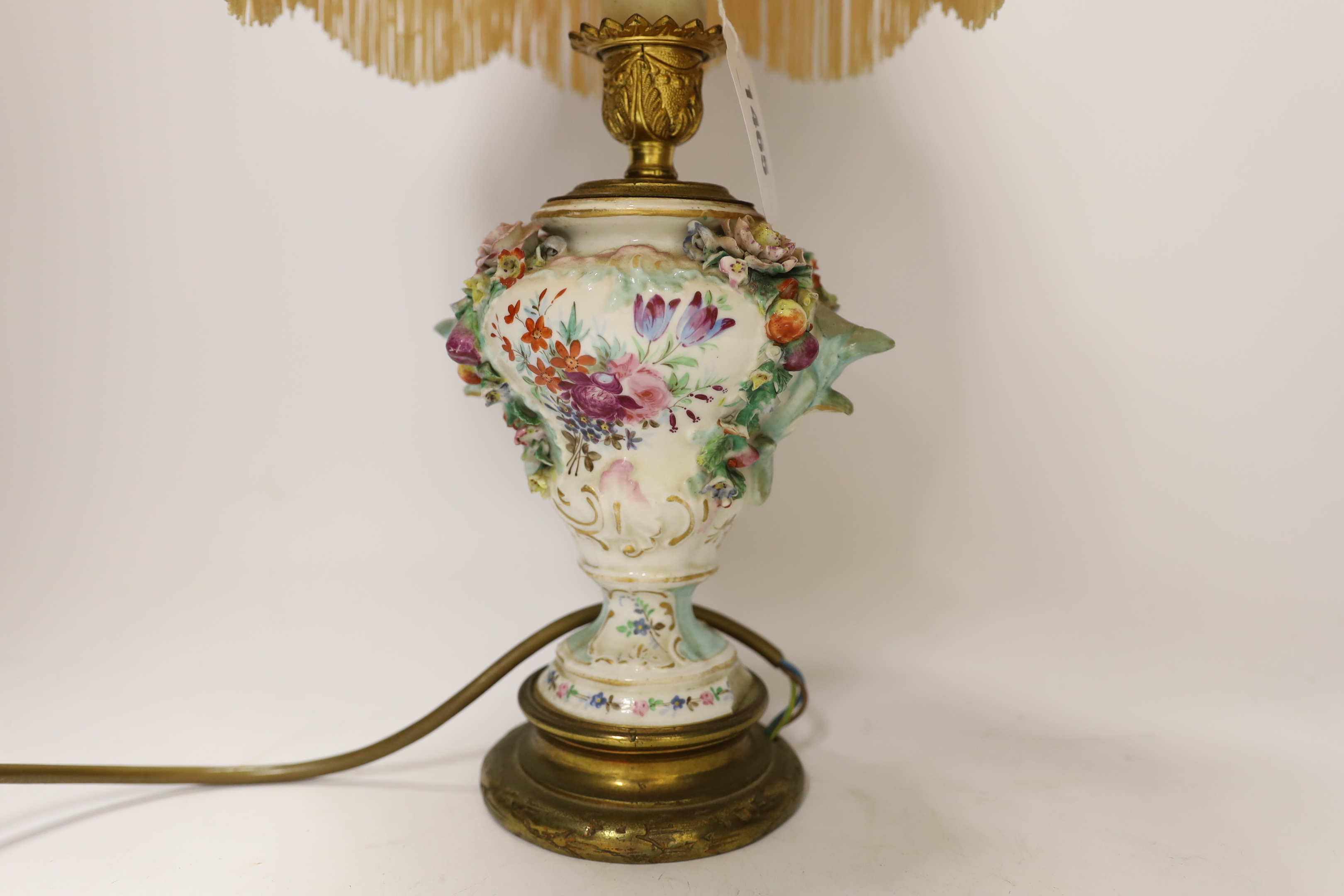 A 19th century floral encrusted table lamp with silk shade, 47cm high